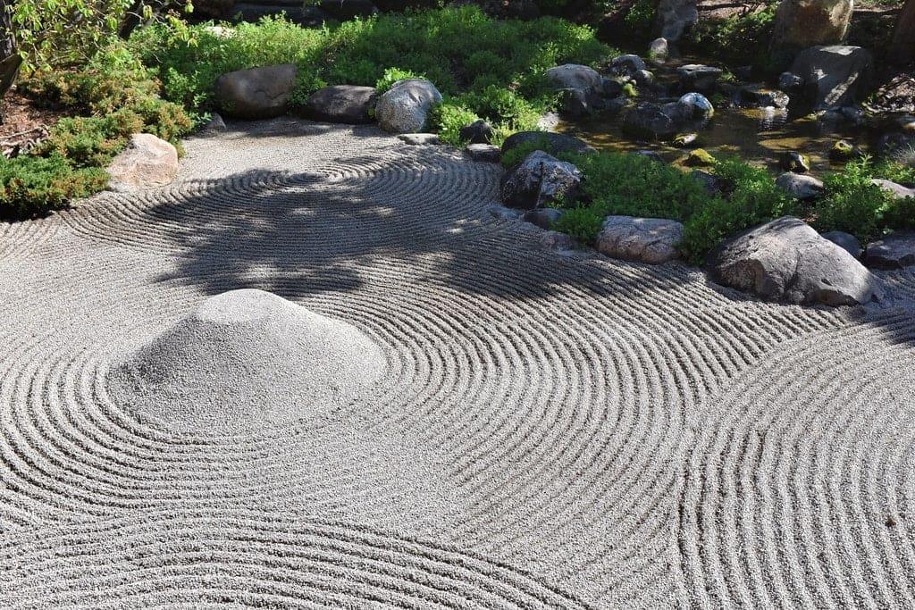 The carefully raked gravel patterns represent the flow of water and tranquility