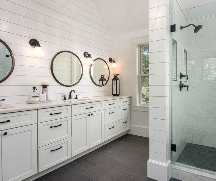 Crisp white palettes brighten farmhouse bathrooms beautifully