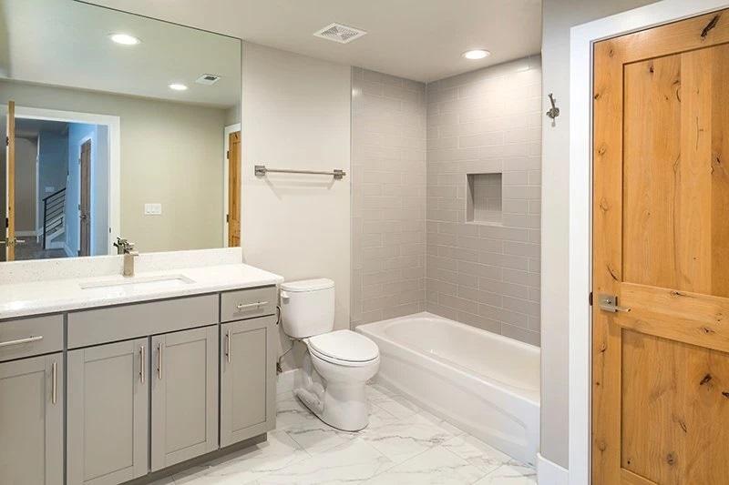 Add recessed lighting for ambiance in your narrow bathroom