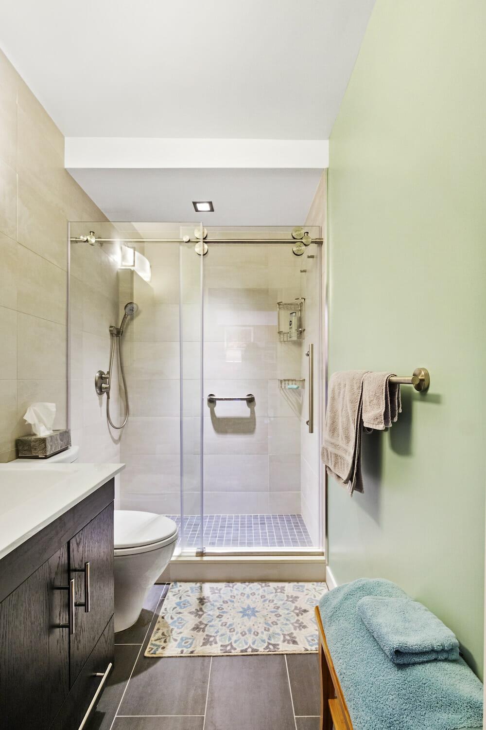 Opt for a glass shower door for an airy feel in small bathrooms