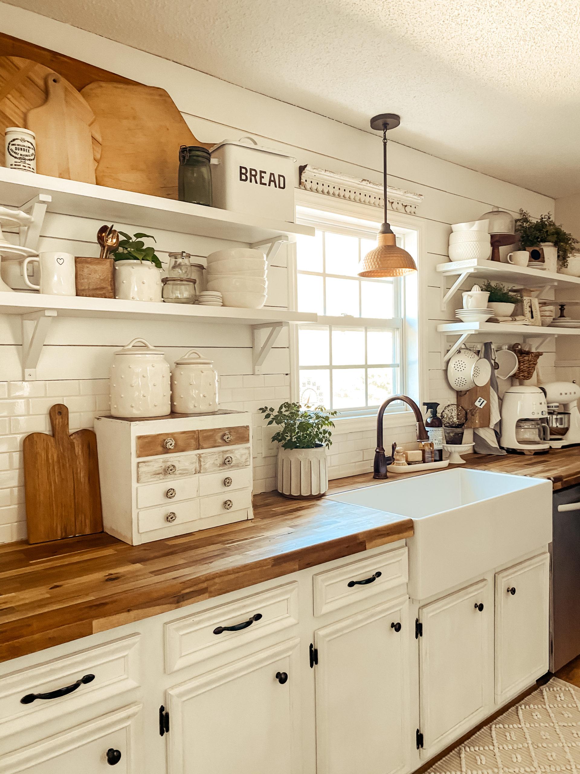 Open shelving showcases pretty dishware in an inviting farmhouse kitchen