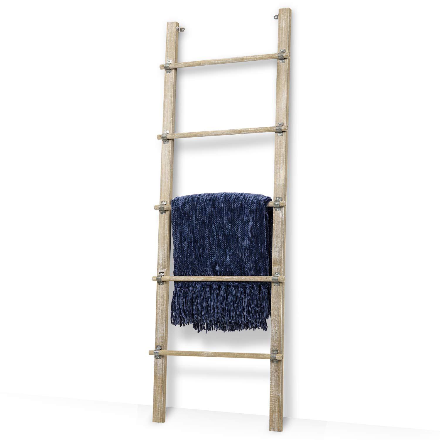 Vintage ladders serve ​as stylish towel​ holders in an eclectic bathroom