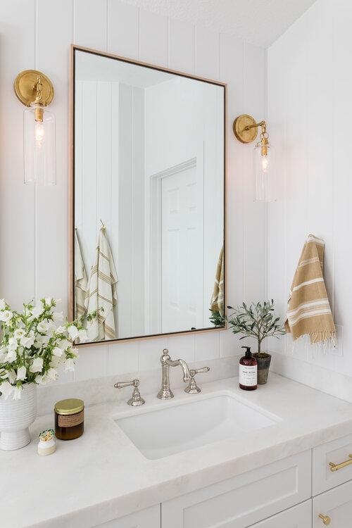 Mix-and-match hardware creates a personalized feel in an eclectic bathroom