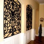 Inset wall niche - wrought iron in square niche with curved top .