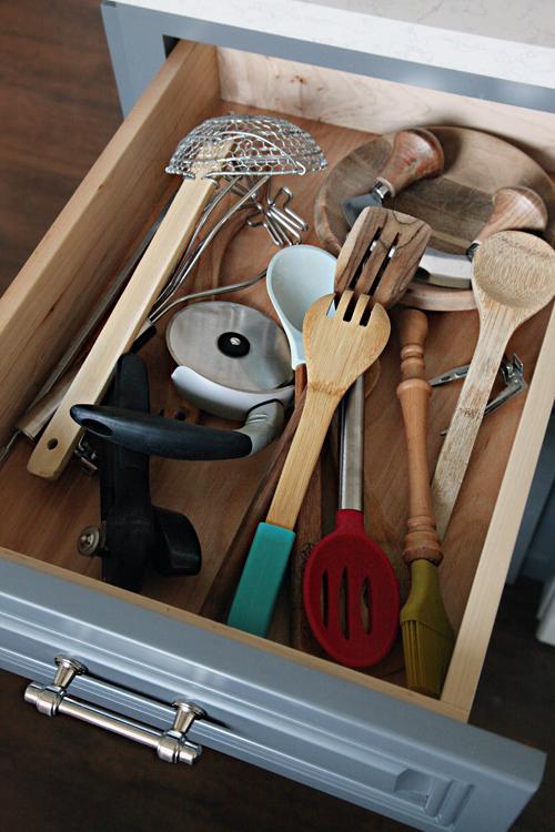 Consider drawer dividers for organized ​utensils in your galley kitchen